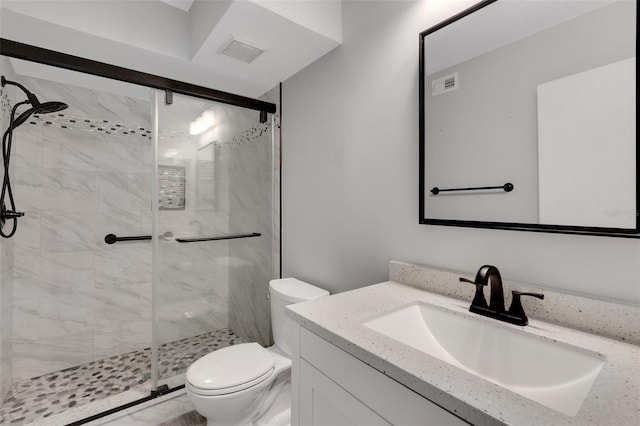 bathroom featuring vanity, toilet, and an enclosed shower