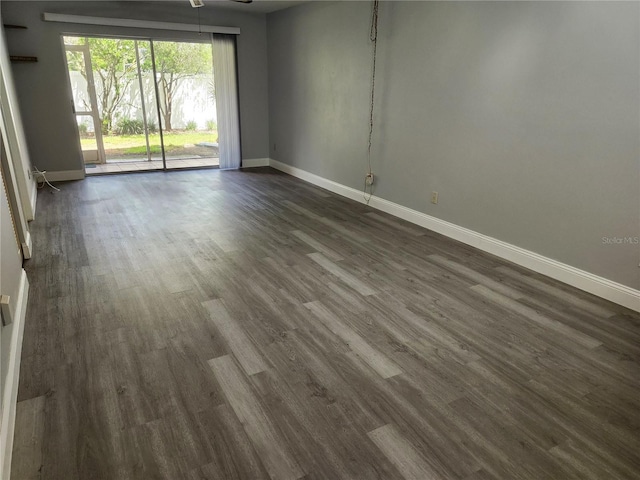 spare room with ceiling fan and dark hardwood / wood-style floors