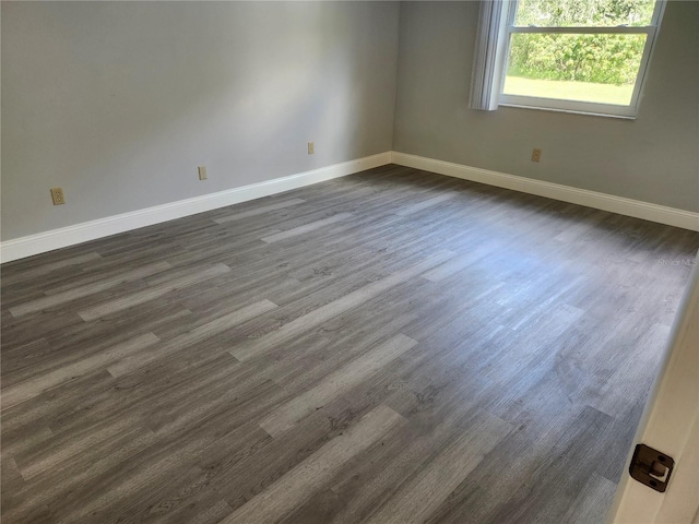 unfurnished room with dark hardwood / wood-style floors