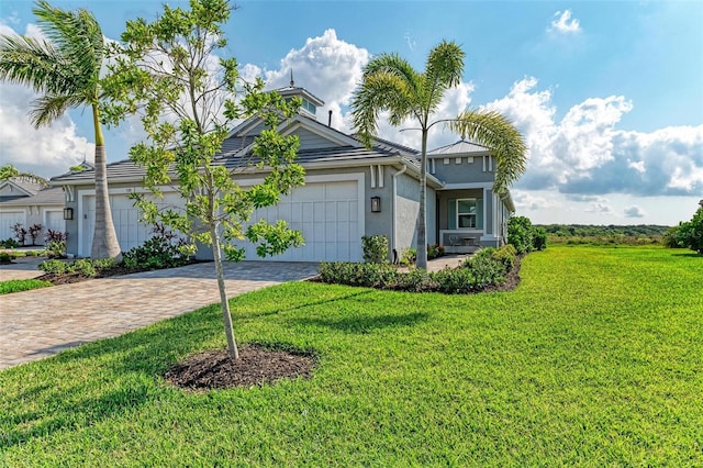 view of front facade with a garage and a front yard