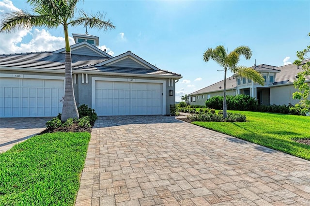 view of front of property with a front lawn and a garage