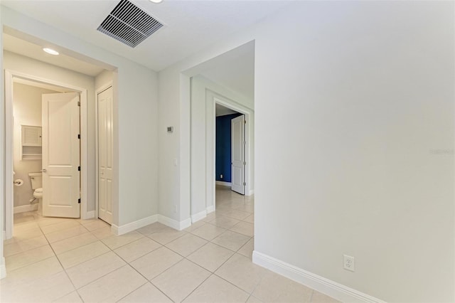 hallway featuring light tile floors