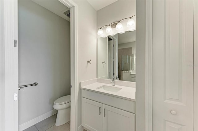 bathroom featuring tile flooring, vanity, and toilet