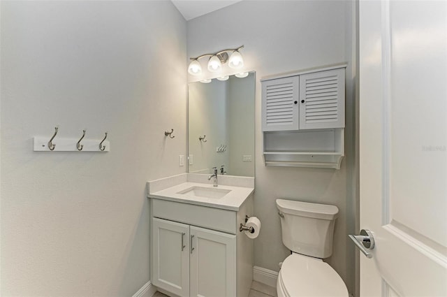 bathroom featuring vanity with extensive cabinet space and toilet