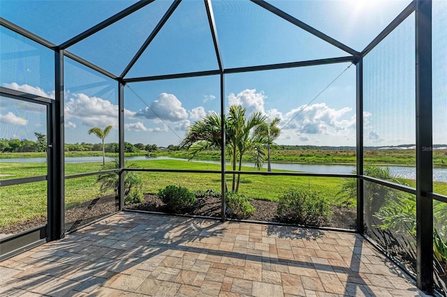 unfurnished sunroom with a water view