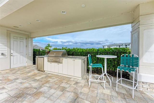 view of terrace featuring area for grilling and an outdoor kitchen