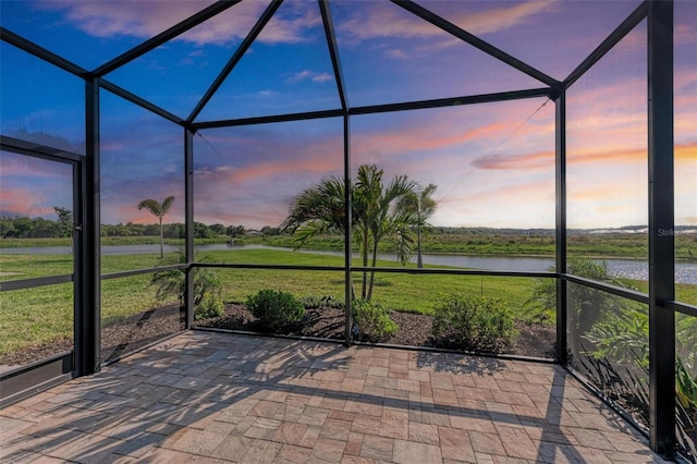 unfurnished sunroom with a water view