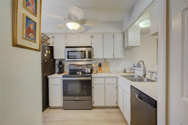 kitchen with white cabinets, sink, ceiling fan, and stainless steel appliances