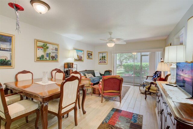 dining space with light hardwood / wood-style floors and ceiling fan