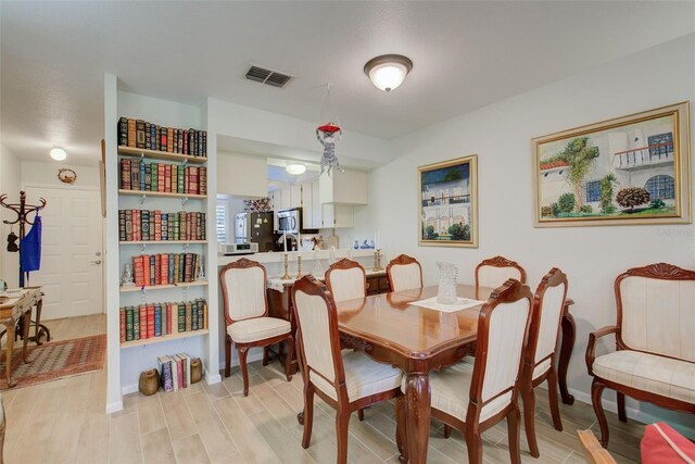 dining space with light wood-type flooring