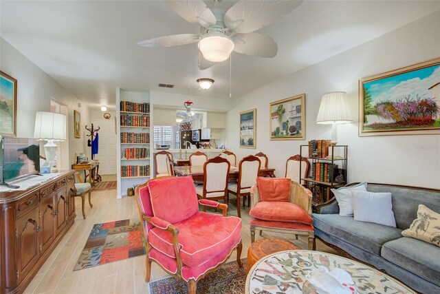 living room featuring light hardwood / wood-style floors and ceiling fan