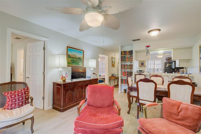 living room with ceiling fan and light wood-type flooring