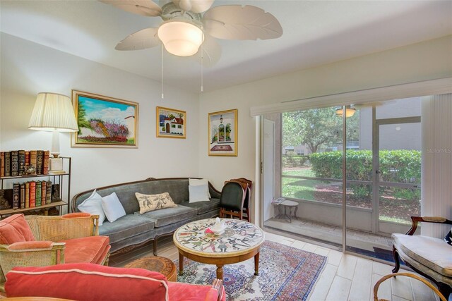 living room featuring light hardwood / wood-style floors and ceiling fan