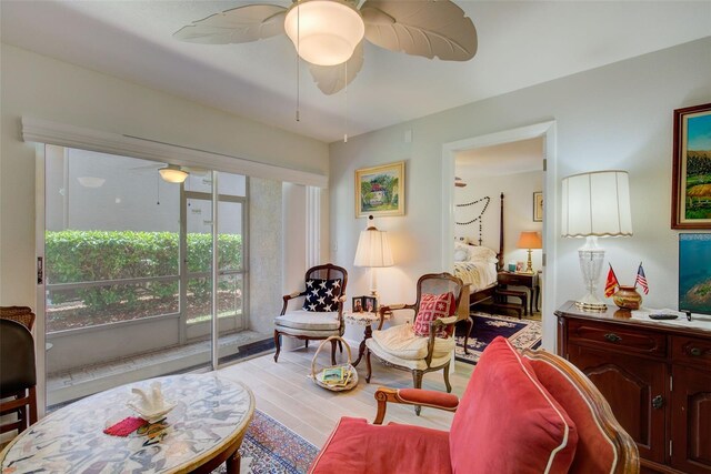 living room with ceiling fan and light hardwood / wood-style floors