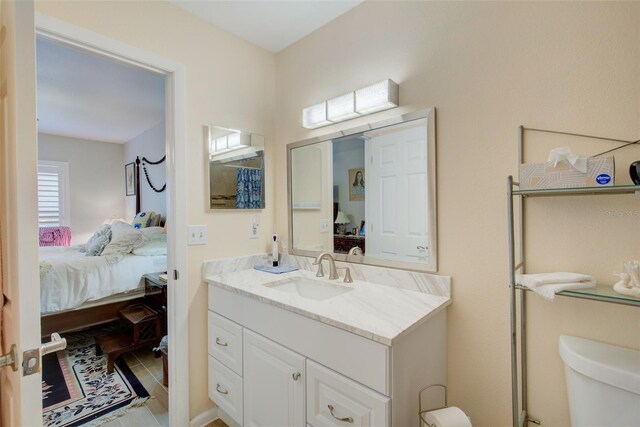 bathroom with toilet, tile floors, and large vanity