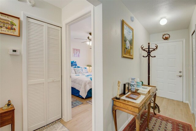 hallway with light hardwood / wood-style floors