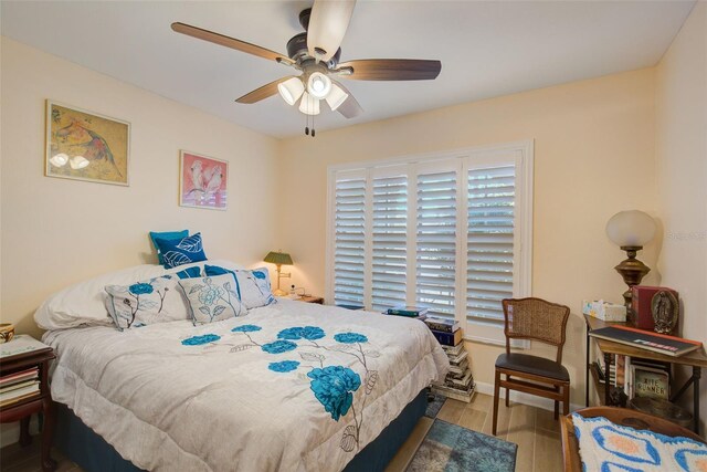 bedroom with wood-type flooring and ceiling fan