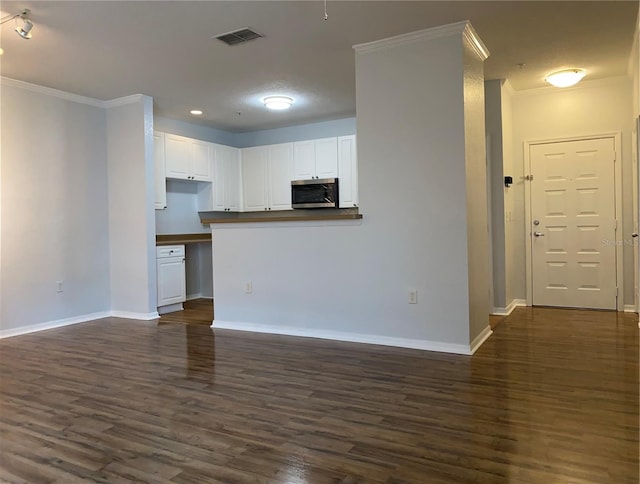 kitchen featuring white cabinetry, crown molding, kitchen peninsula, and dark hardwood / wood-style floors