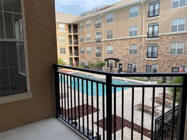 balcony featuring a community pool