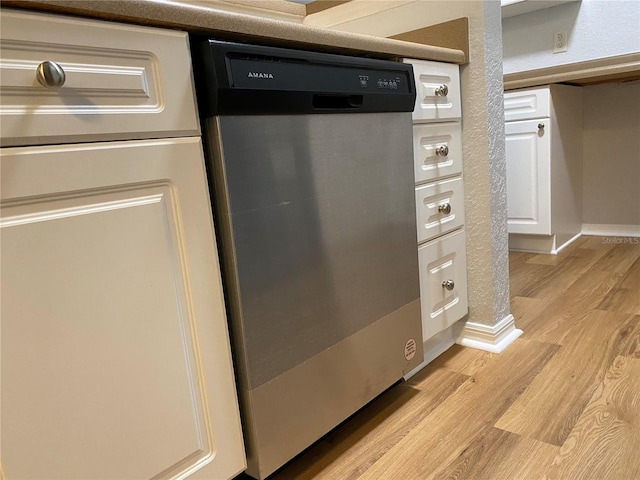 room details with light hardwood / wood-style flooring and dishwasher