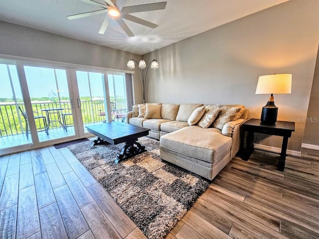 living room with wood-type flooring and ceiling fan