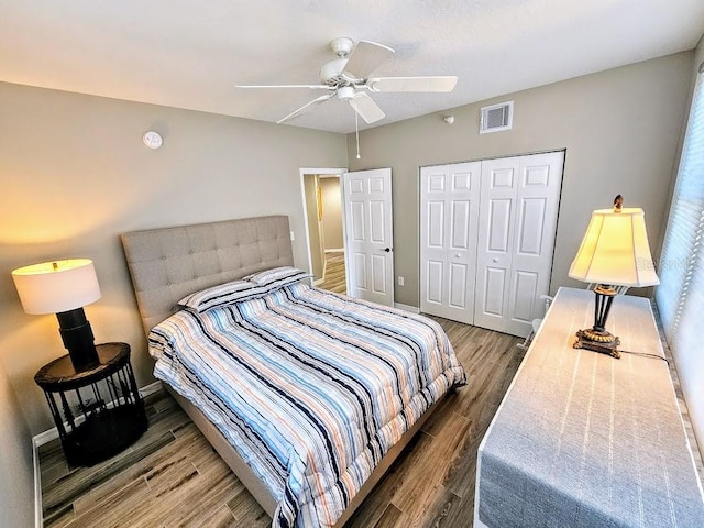 bedroom featuring dark hardwood / wood-style floors, a closet, and ceiling fan