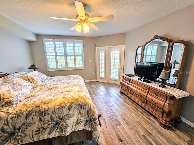 bedroom featuring ceiling fan, a textured ceiling, and hardwood / wood-style flooring