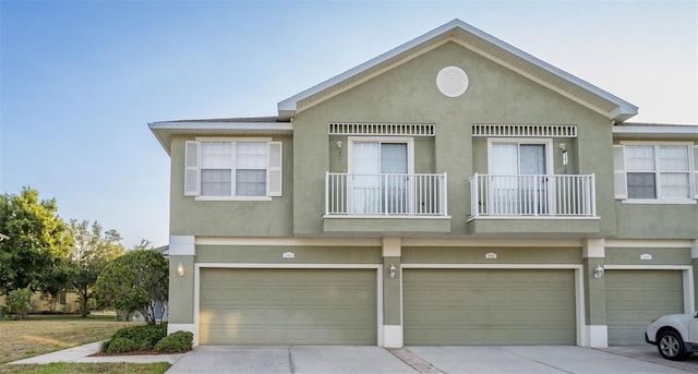 multi unit property with a garage and a balcony