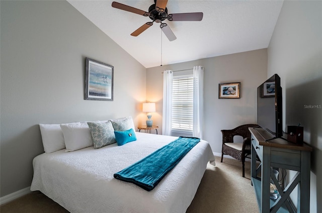 carpeted bedroom with ceiling fan and vaulted ceiling