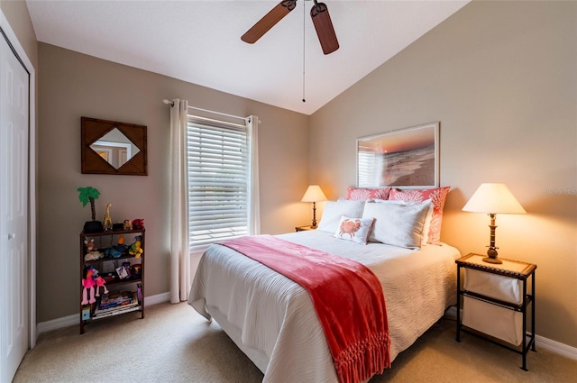 bedroom featuring vaulted ceiling, a closet, carpet floors, and ceiling fan