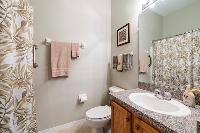 bathroom featuring toilet, a shower with shower curtain, tile patterned floors, and vanity