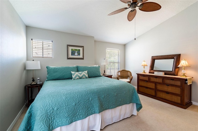 bedroom with vaulted ceiling, ceiling fan, a textured ceiling, and light colored carpet