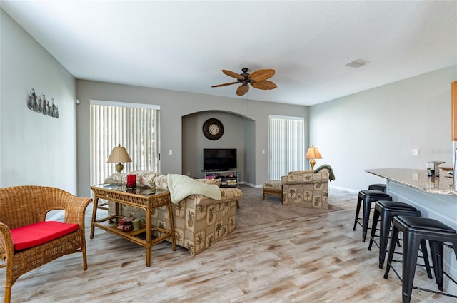 living room featuring ceiling fan and light wood-type flooring