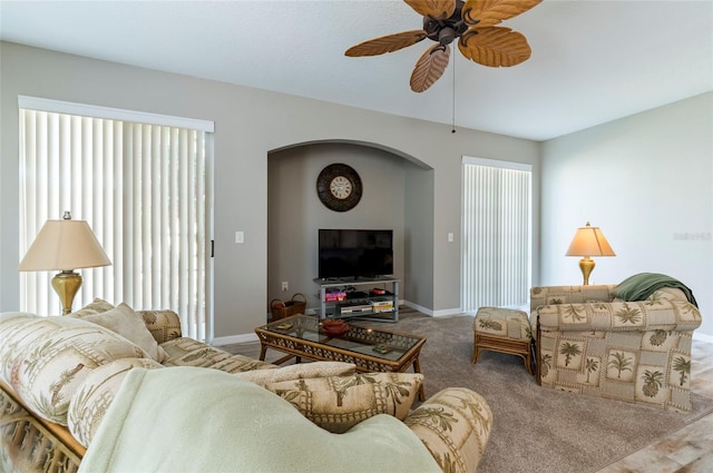 carpeted living room featuring ceiling fan