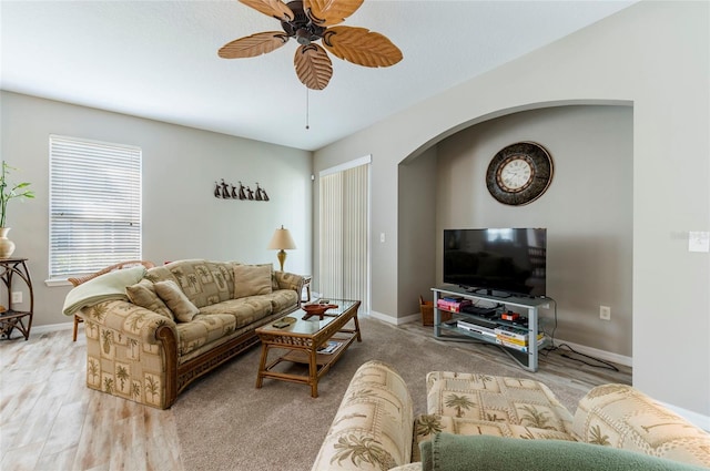 living room featuring ceiling fan and light hardwood / wood-style flooring