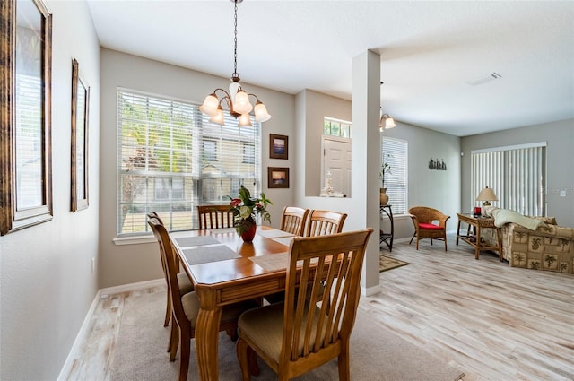 dining room with a notable chandelier and light hardwood / wood-style floors