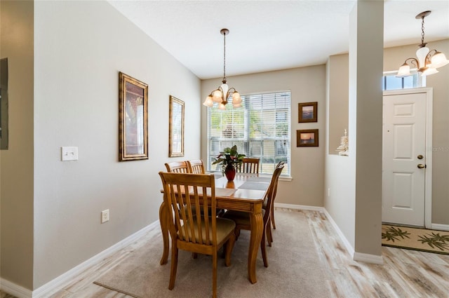 dining room featuring an inviting chandelier and light hardwood / wood-style flooring