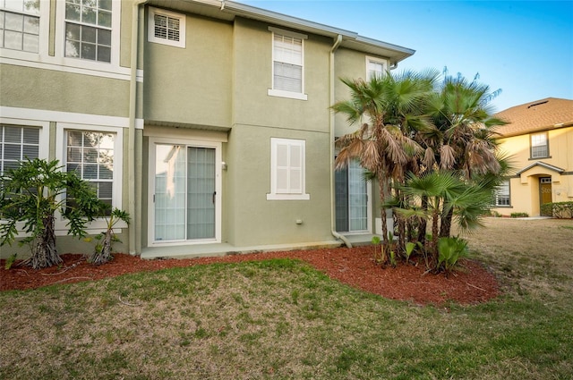 rear view of property with a lawn