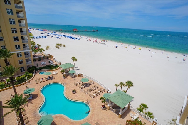 view of swimming pool featuring a beach view and a water view