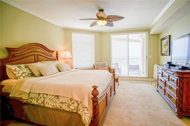 carpeted bedroom with ornamental molding, ceiling fan, and multiple windows