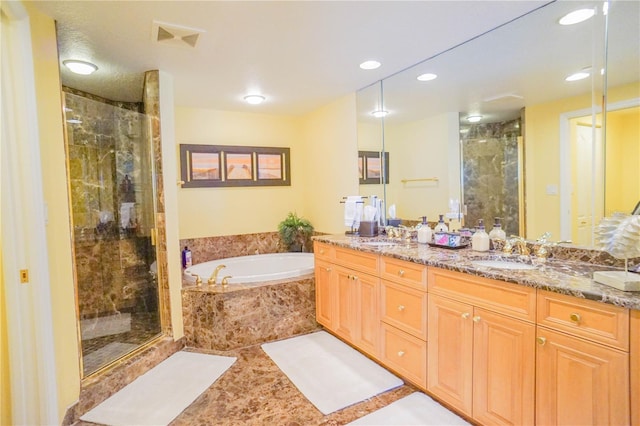 bathroom featuring independent shower and bath, oversized vanity, double sink, and tile floors