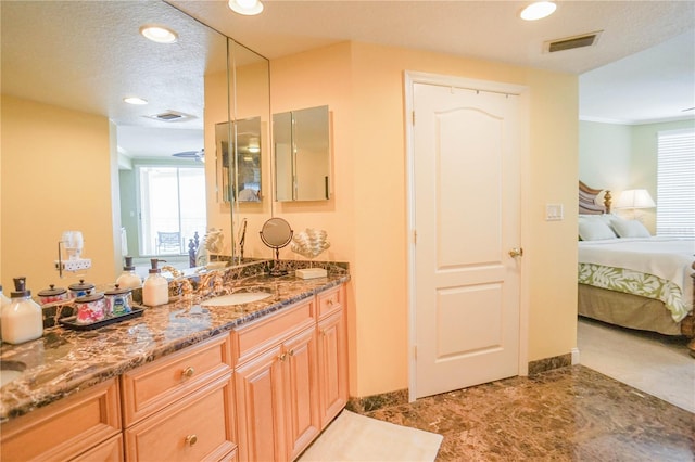 bathroom with a textured ceiling and vanity