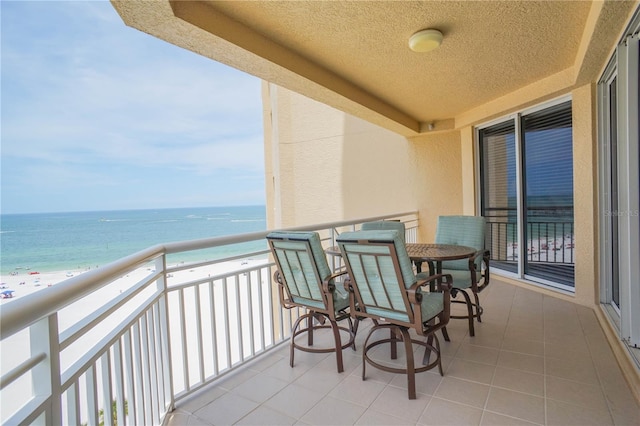 balcony with a view of the beach and a water view