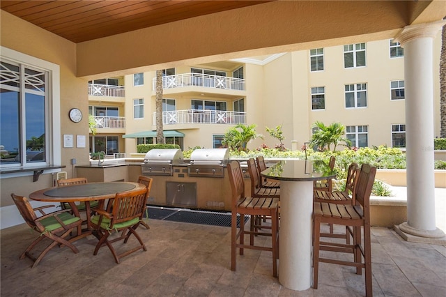 view of patio featuring a balcony and area for grilling