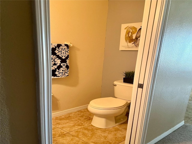 bathroom with tile patterned flooring and toilet