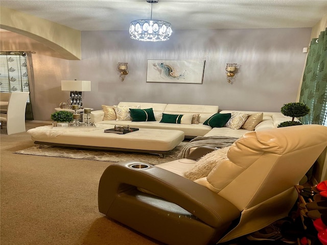 living room featuring carpet flooring, a textured ceiling, and an inviting chandelier