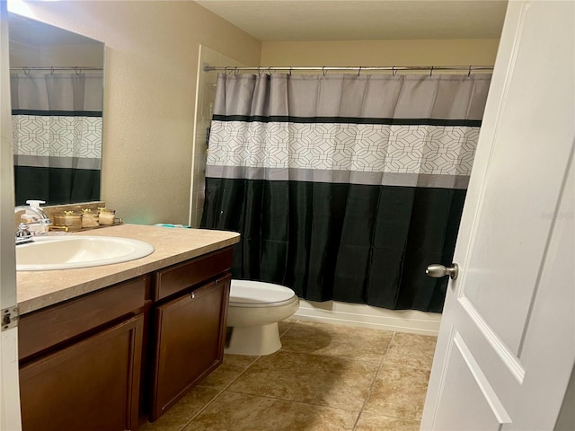 bathroom with vanity, tile patterned flooring, and toilet