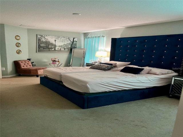 carpeted bedroom with a textured ceiling