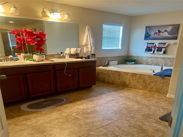 bathroom with double vanity, tiled bath, and tile patterned floors