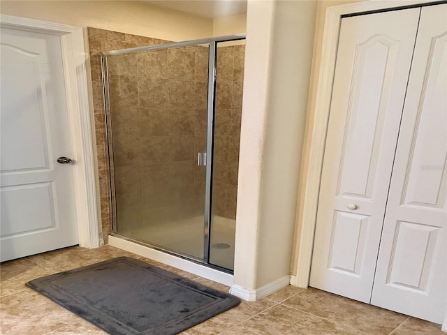 bathroom with tile patterned flooring and walk in shower